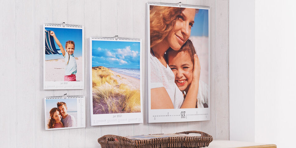 Selection of small to large photo calendars hanging on the wall