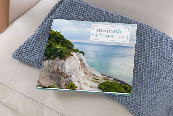 extra large square photo book closed showing matte finish coastal cover image.