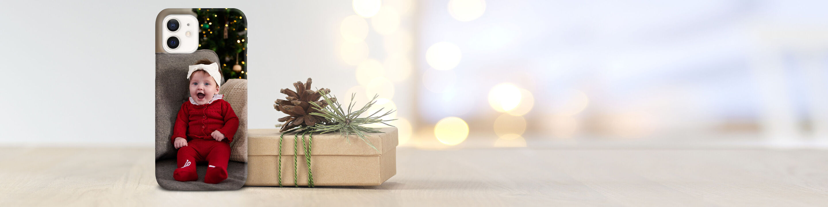 A lovingly designed smartphone case with a festive motif and a decorative gift box.