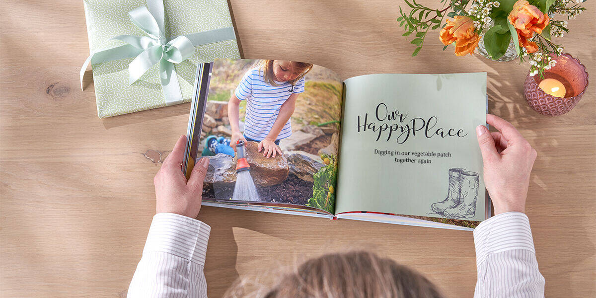 Square photo book open to pages showing grandkids gardening