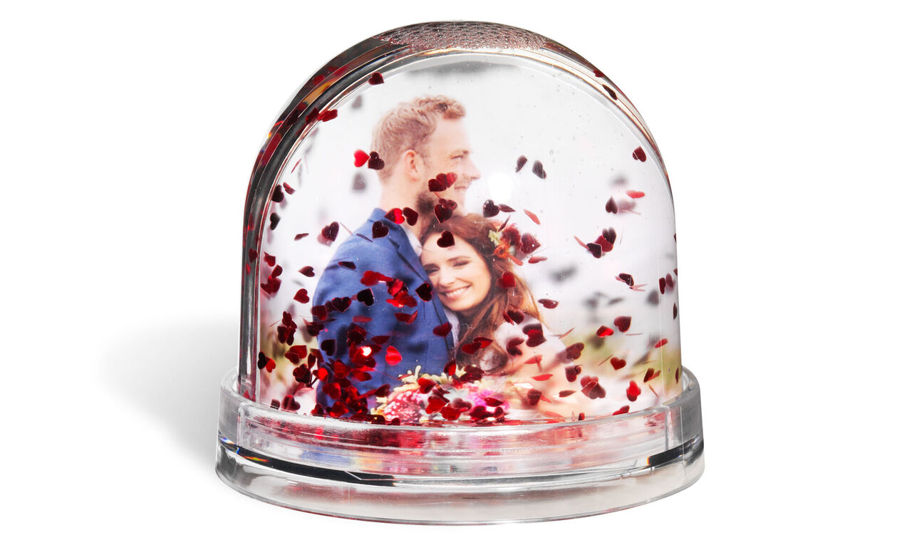Personalised globe with hearts falling around image of couple on wedding day